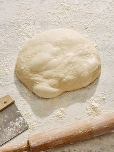 a pizza dough and rolling pin on a table