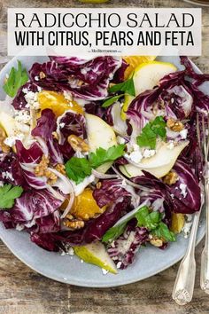 a salad with apples, oranges and nuts on a gray plate sitting on a wooden table