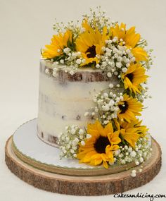 a cake with sunflowers and baby's breath on top