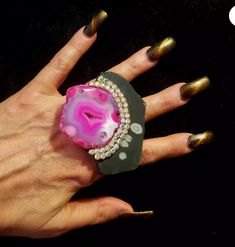 Here is a gorgeous pink druzy agate and snowflake jasper slab Statement Ring, unworn, from my personal collection. This Art Deco inspired Cocktail Ring measures 3" x 2.75" and shows a high end hot pink druzy agate mounted onto a black snowflake jasper slab accented with silver Aurora Borealis Rhinestones. This piece of sexy jewelry is pure glamour and made for most with a silvertone adjustable mount that will adjust to fit nearly all. This OOAK and unique ring is from the Atelier of Kat Kouture! Unique Agate Crystal Ring For Gift, Unique Agate Crystal Ring Gift, Luxury Agate Jewelry For Statement Piece, Unique Agate Geodes For Gift, Unique Agate Geodes, Luxury Hand-strung Agate Jewelry, Pink Hand-strung Agate Jewelry, Pink Agate Hand-strung Bracelets, Pink Agate Pendant Jewelry