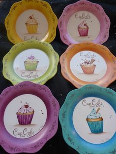 six colorful plates with cupcakes painted on them