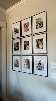 a bunch of pictures are hanging on the wall in front of a light switch box