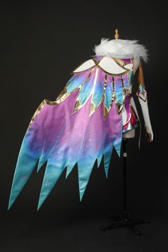 a mannequin dressed in colorful clothing with feathers