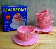 teacupcake cups and saucers in front of a box on a wooden table