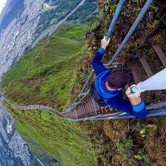 a man standing on top of a glass walkway