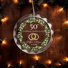 a 50th anniversary ornament hanging from a christmas tree