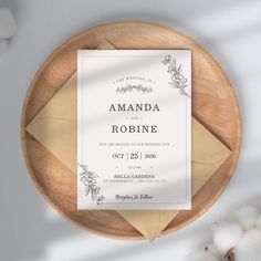 a wedding card on a wooden plate with cotton