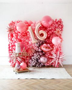 balloons and decorations are arranged in the shape of a number sixteen, surrounded by stars