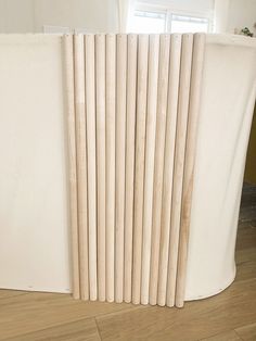 a white radiator sitting on top of a hard wood floor