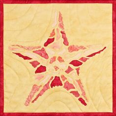 a quilted star with red and yellow colors on the center is in front of a white background