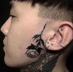 a close up of a person with tattoos on their neck and behind the ear,