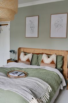 a bed in a bedroom with two pictures on the wall