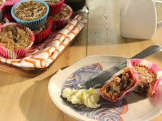 there is a plate with food on it next to a bowl of cereal and cupcakes