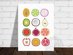 a poster with fruit on it sitting next to a brick wall in front of a wooden floor