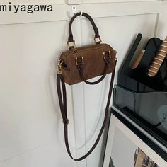 SPECIFICATIONSBrand Name: miyagawaHandbags Type: Shoulder BagsTypes of bags: Shoulder & HandbagsMain Material: POLYESTERLining Material: POLYESTERShape: PillowPlace Of Origin: HE BEI ProvincePlace Of Origin: HE BEI ?ProvinceOrigin: Mainland ChinaCN: AnhuiHardness: SOFTPattern Type: SolidInterior: Interior CompartmentDecoration: noneExterior: Silt PocketOccasion: VersatileClosure Type: zipperGender: WOMENStyle: vintageModel Number: 6A529Number of Handles/Straps: Three Brown Everyday Bag For Winter, Everyday Brown Winter Bag, Winter Rectangular Bag With Adjustable Strap, Winter Bags With Adjustable Strap And Rectangular Shape, Winter Bag With Adjustable Strap, Rectangular Winter Bag With Adjustable Strap, Winter Travel Brown Shoulder Bag, Winter Rectangular Shoulder Bag With Adjustable Strap, Winter Satchel Bag With Adjustable Strap