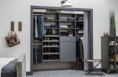 an organized closet with clothes, shoes and other items in it's storage area