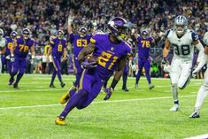 the football players are running on the field