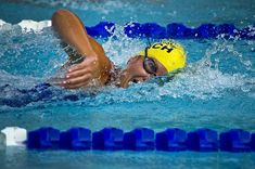 a woman swimming in a pool with the words muscle building 1015 day