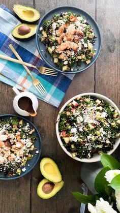 two bowls filled with salad next to an avocado