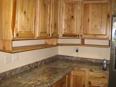 a kitchen with wooden cabinets and granite counter tops