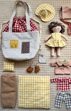 doll clothes and accessories laid out on the floor