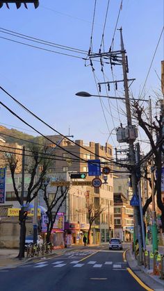 an empty street with power lines above it