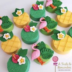 there are many decorated pineapples and flamingos on the cake topper together