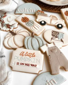 some cookies are laying on a table with other items in the shape of pumpkins