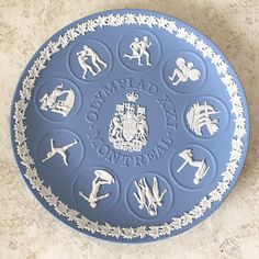 a blue plate with white designs on it sitting on top of a marble countertop