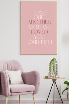 a pink chair sitting next to a table with a potted plant on top of it