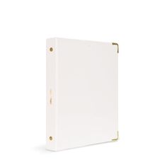 a white binder with gold trimmings on the front and bottom, against a white background