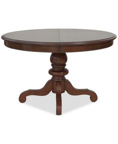 a wooden table with an oval top and two leaves on the base, in dark wood