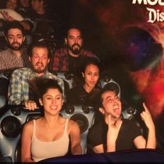 a group of people sitting in front of a movie poster with the words model district on it