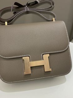 Hermes Constance 18Etoupe Epsom RGHWSize 18 x 14 x 5cmZ StampMar 2022New w SealIncludes full set box, dust bag and receiptPrice now 19,200 sgd 14,350 usd CN5474-01 Hermes New Bags, Hermes Constance Bag Outfit, Constance Hermes, Hermes Bags Constance, Constance Bag Hermes, Most Expensive Hermes Bag, Vintage Hermes Crossbody Bag, Hermes Constance Wallet To Go, Limited Edition Hermes Bags