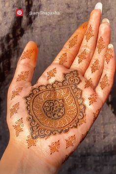 a woman's hand with henna on it