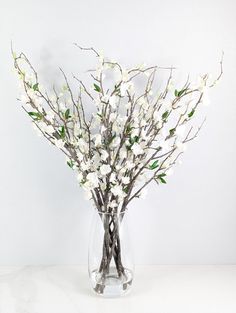 a vase filled with white flowers on top of a table