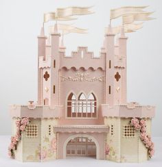 a pink and white castle made out of paper