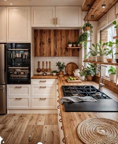 a kitchen with white cabinets and wooden counter tops is pictured in this image, there are potted plants on the stove