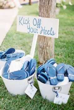 two buckets filled with blue candles next to a sign that says kick off your heels