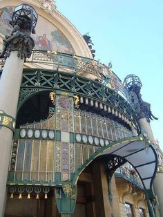 an ornately decorated building with statues on top