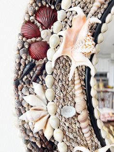 a mirror that has shells and seashells on it