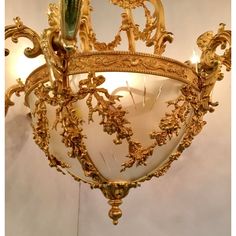 an ornate gold chandelier hanging from the ceiling