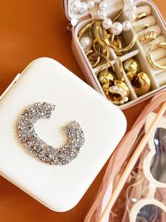 an assortment of jewelry in a box on a table