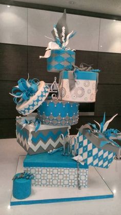 a large stack of blue and white gift boxes