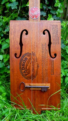 two pictures of an old wooden door in the grass and one has a sign on it