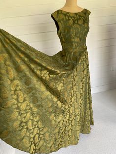 Beautiful quality, elegant, woven silk brocade with abstracted ancient floral Persian 'Gul' motif. Bias cut, high front neckline with straight waist, extended shoulder sleeve cut, V shape back neckline and V shape back pleated waist. Brass side zip. Absolutely stunning on, fabric has a small number of pin size holes un noticeable whilst on, price reflects this. Would be a perfect piece to alter to your own sizing. Current size would fit a 10 - 12 and see measurements listed. Please see individua Green Brocade Formal Dress, Formal Green Brocade Dress, Green Brocade Dress For Formal Occasions, Fitted Brocade Dresses, Vintage Brocade Fitted Dress, Fitted Vintage Brocade Dress, Elegant Formal Dress With Vintage Pattern, Elegant A-line Dress With Vintage Pattern, Extended Shoulder Sleeve