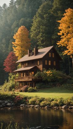 a large house sitting on top of a lush green hillside next to a lake and forest