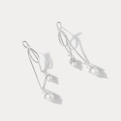 Elevate your elegance with our Silver Lily Of The Valley Bow Earrings. Crafted in sterling silver, these delicate earrings showcase the iconic Lily of the Valley motif in a charming bow design. A touch of femininity and nature-inspired grace, these earrings are perfect for adding a subtle yet timeless accent to your look.  🎀 DETAILS Materials:  Sterling  Silver, Pearl Size: 2.09"* 0.31 "(5.3cm*0.8cm) Weight: 7.4g/pr Elegant Silver Drop Wrap Earrings, Silver Sterling Pearl Drop Linear Earrings, Delicate Silver Linear Earrings For Formal Occasions, Elegant Sterling Silver Wrap Earrings, Elegant Sterling Silver Wrap Earrings For Anniversary, Elegant Silver Wrap Earrings, Elegant Silver Wrap Earrings For Anniversary, Sterling Silver Pearl Earrings With Ear Wire For Party, Dainty Silver Drop Wrap Earrings