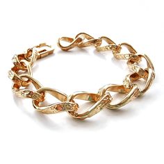 Beautiful, chunky vintage chain bracelet in shiny, textured gold with a smart, secure clasp. This is a classic piece of jewellery adaptable to many different styles. Made in the 80's, it's been locked away for over 20 years in a disused factory, in England - awaiting its big come back! The factory produced high quality jewellery for England's fanciest names and department stores, starting with Selfridges, Harvey Nichols and Frank Usher. Metal. Made in England. The chain measures 1.1cm wide and 1 Vintage Gold Bracelet With Chain, Gold Metal Chain Bracelet For Party, Party Gold Chain Bracelet, Gold Chain Link Charm Bracelet, Gold Metal Chain Link Bracelet, Metal Chunky Chain Bangle Bracelet, Chunky Chain Link Metal Bracelets, Gold Chain Bracelet With Solid Links For Parties, Vintage Metal Bracelets With Gold Chain