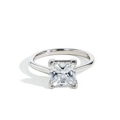 a white gold ring with a princess cut diamond